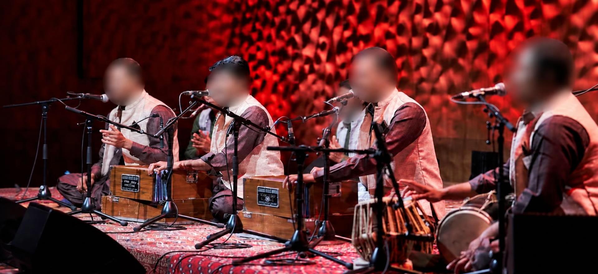 Four brothers performing Qawwali, with all faces completely obscured